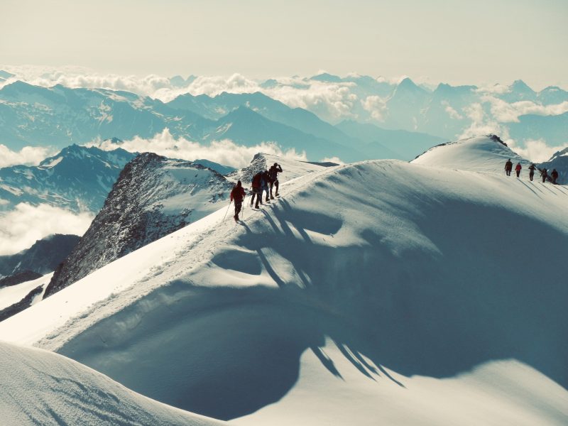Wandergruppe auf dem schneebedecktem Gipfel unterwegs zur Traumaarbeit in Oberbayern
